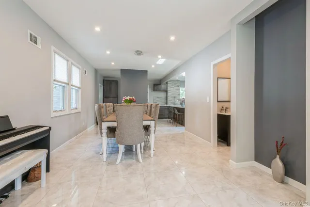 a dining room with furniture and window