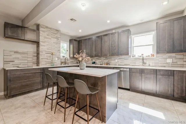 a kitchen with a sink window and cabinets