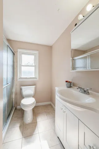 a bathroom with a sink toilet and a mirror
