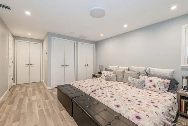 a bedroom with a large bed and a chandelier