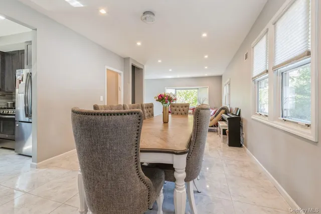 a dining room with furniture and a window