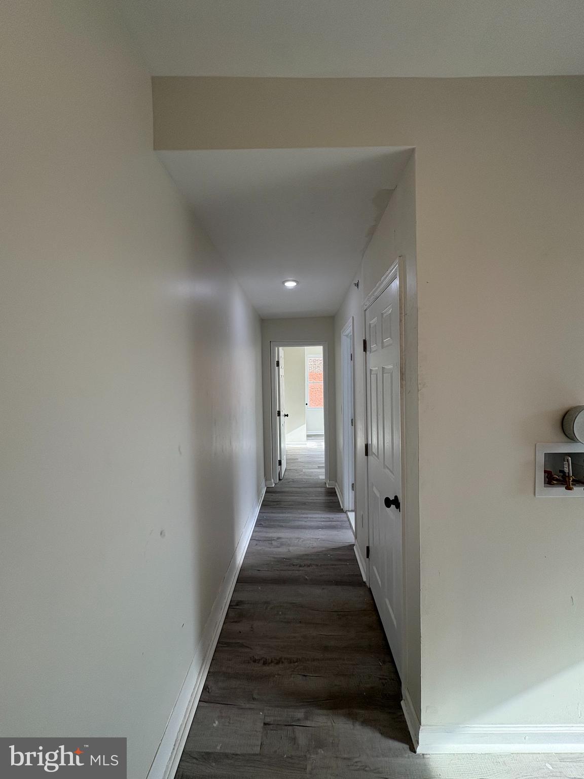 3625 North 22nd Street, Unit 2 Philadelphia, PA 19140 - Photo 4 of 10 a view of a hallway with wooden floor and a bathroom