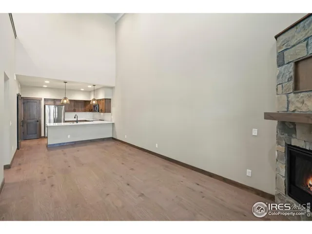 a view of a hallway with wooden floor and a fireplace