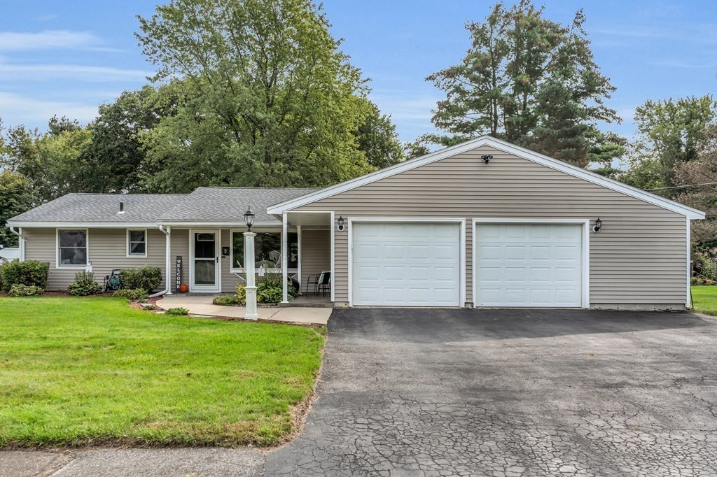 5 Colby Road Danvers, MA 01923 - Photo 2 of 33 a front view of a house with a yard and trees