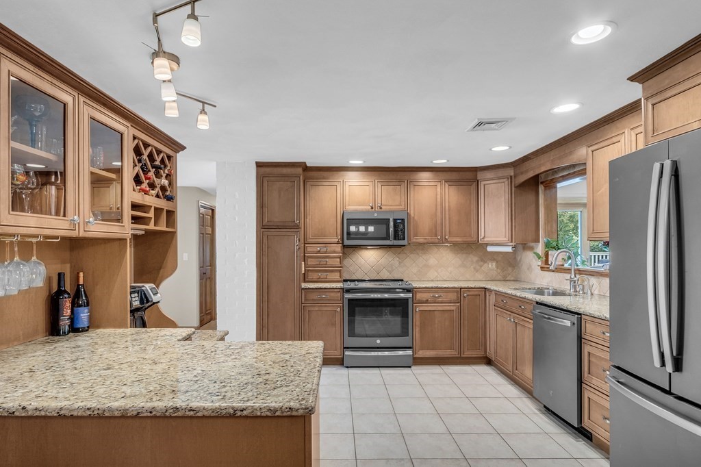 5 Colby Road Danvers, MA 01923 - Photo 9 of 33 a kitchen with stainless steel appliances granite countertop a refrigerator and a sink