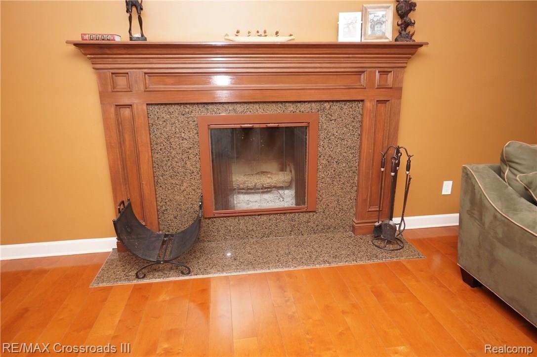 15487 Haggerty Road Belleville, MI 48111 - Photo 21 of 82 Granite and Wood fireplace