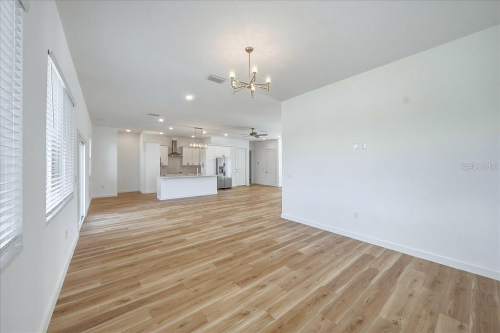1215 Rio De Janeiro Avenue Punta Gorda, FL 33983 - Photo 19 of 65 a view of an empty room with a kitchen
