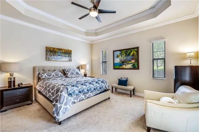 a bedroom with a bed and ceiling fan