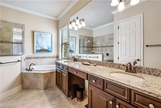 a spacious bathroom with a granite countertop sink a large mirror and a bathtub