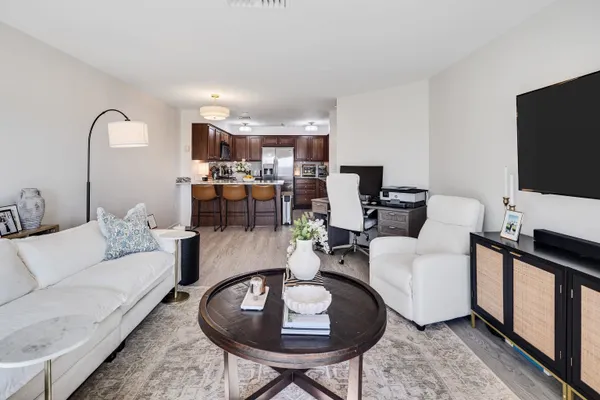 a living room with furniture a rug and a flat screen tv