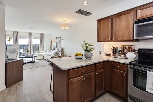 a kitchen with a sink stove and microwave