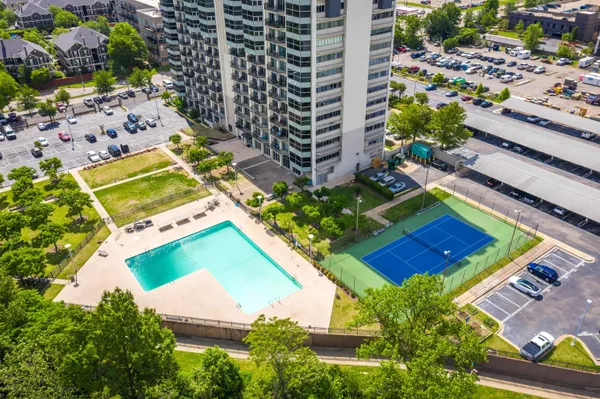 an aerial view of a tennis ground with large trees