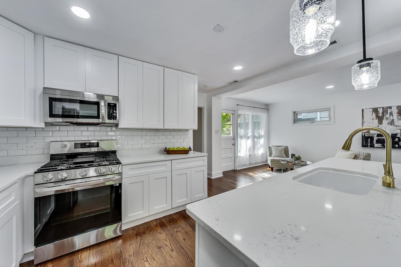 1211 West Talcott Road Park Ridge, IL 60068 - Photo 17 of 57 a kitchen with a stove a sink and a microwave