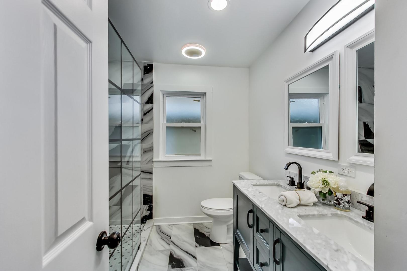 1211 West Talcott Road Park Ridge, IL 60068 - Photo 21 of 57 a bathroom with a granite countertop sink toilet and shower
