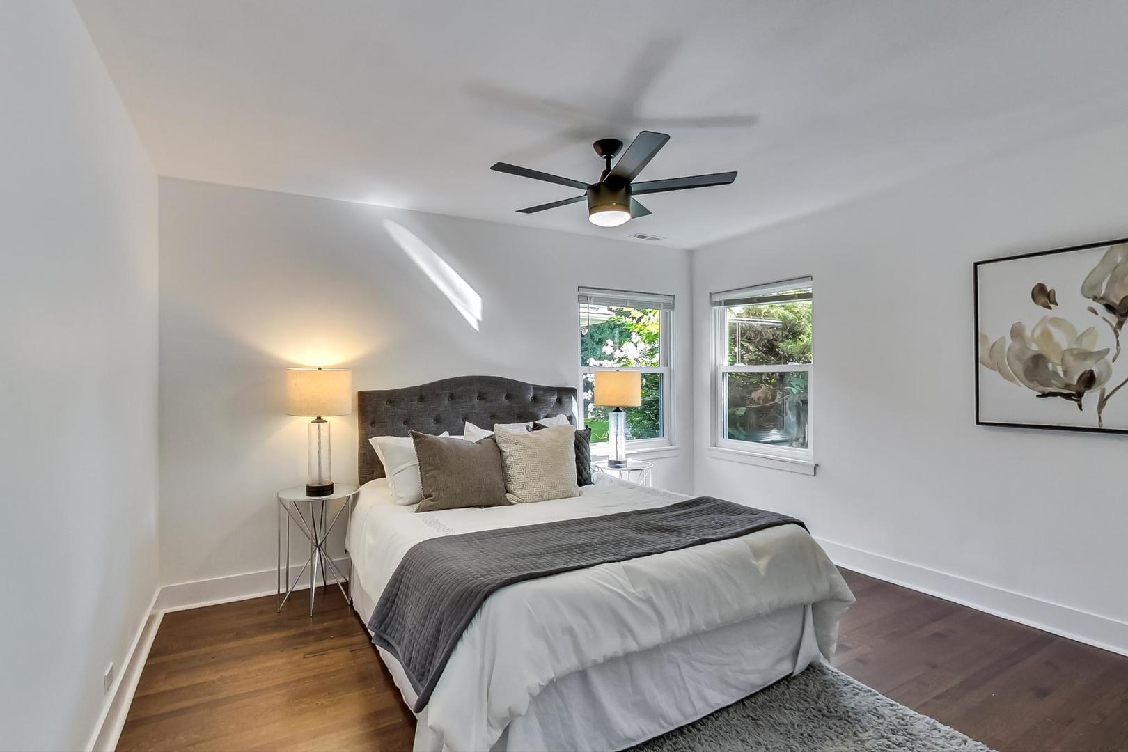 1211 West Talcott Road Park Ridge, IL 60068 - Photo 23 of 57 a bedroom with a large bed and a chandelier
