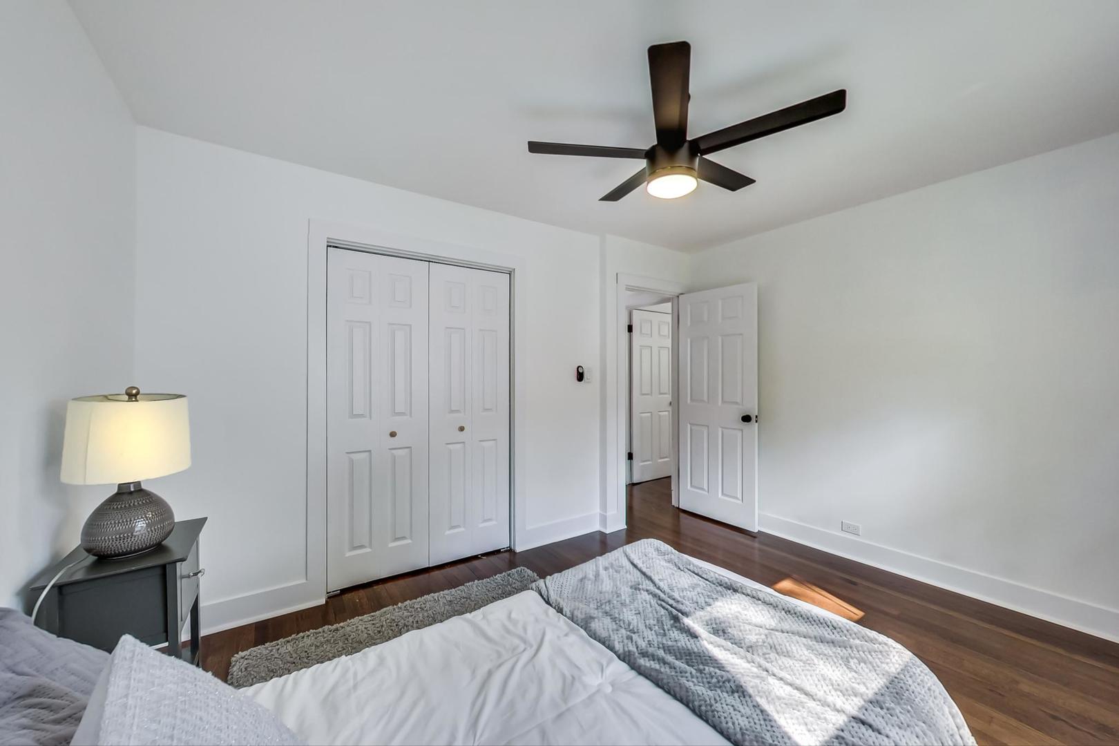 1211 West Talcott Road Park Ridge, IL 60068 - Photo 27 of 57 a bedroom with a bed and a lamp
