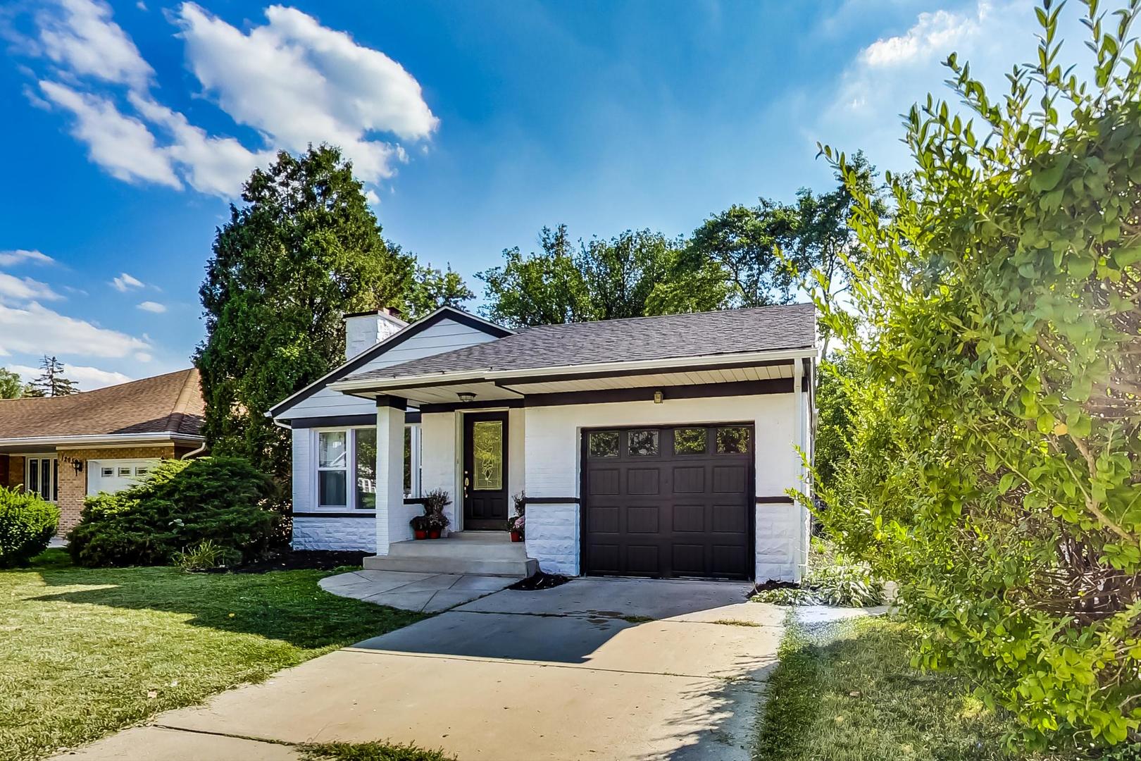 1211 West Talcott Road Park Ridge, IL 60068 - Photo 3 of 57 a front view of a house with a garden