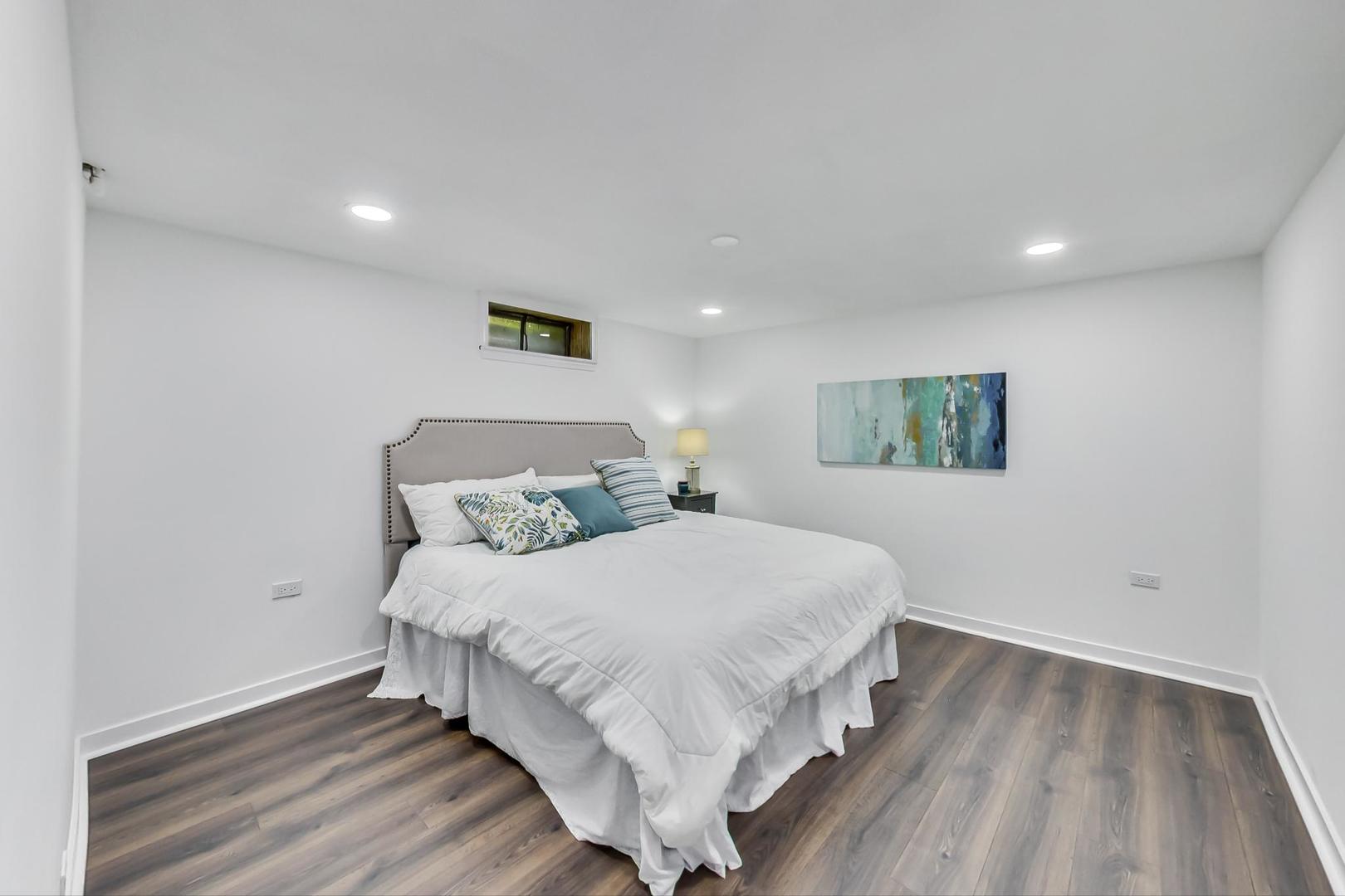 1211 West Talcott Road Park Ridge, IL 60068 - Photo 40 of 57 a large bed sitting in a room next to a lamp