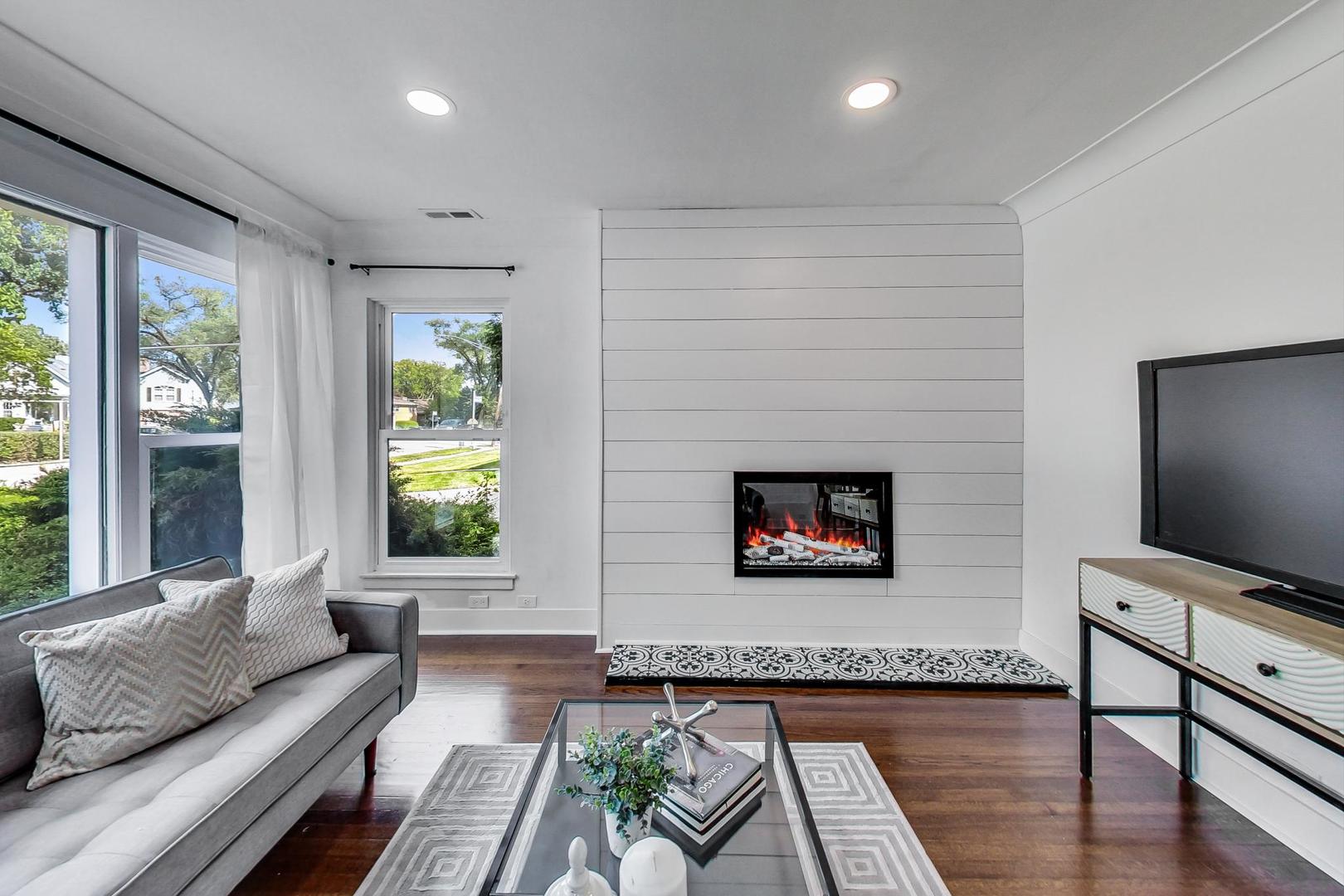 1211 West Talcott Road Park Ridge, IL 60068 - Photo 10 of 57 a living room with furniture a flat screen tv and a fireplace