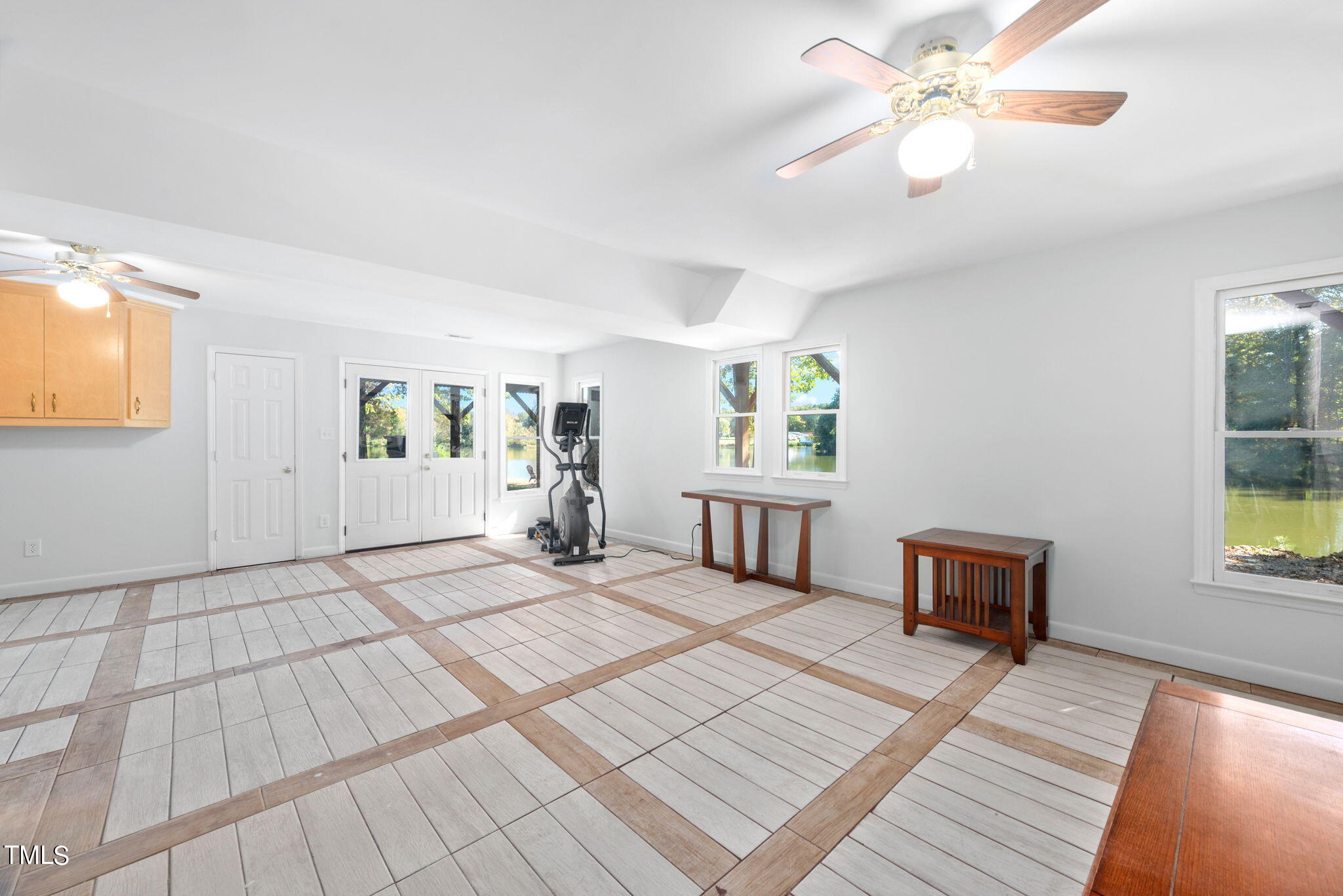 427 Mason Road Durham, NC 27712 - Photo 17 of 29 a spacious bedroom with a bed a chandelier and a window