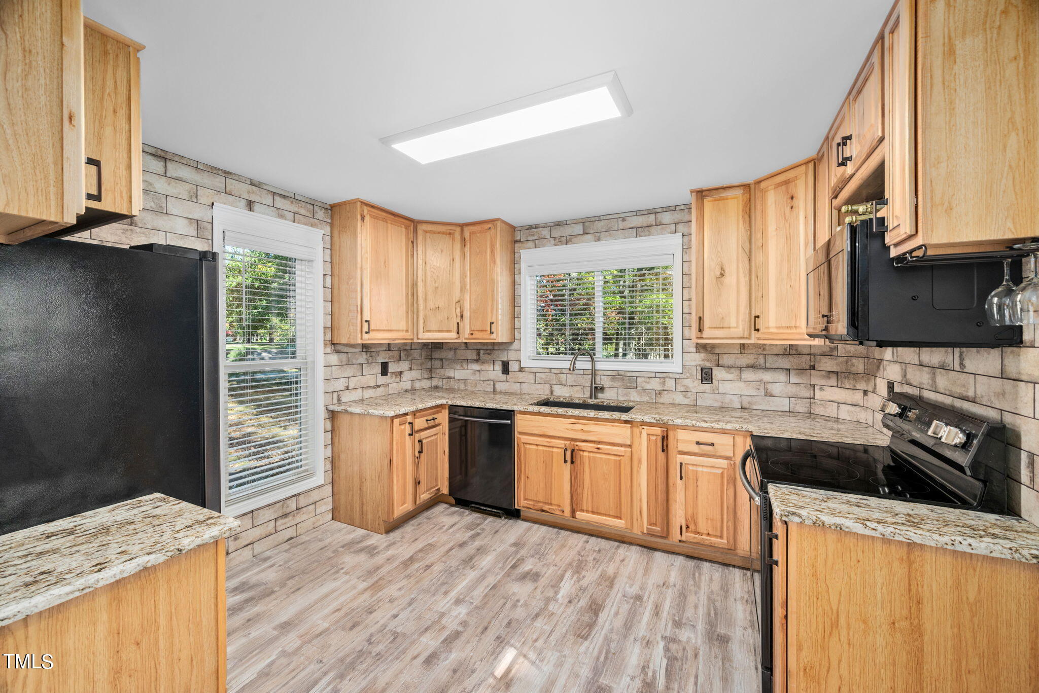 427 Mason Road Durham, NC 27712 - Photo 4 of 29 a kitchen with stainless steel appliances granite countertop wooden floor sink stove and granite counter top