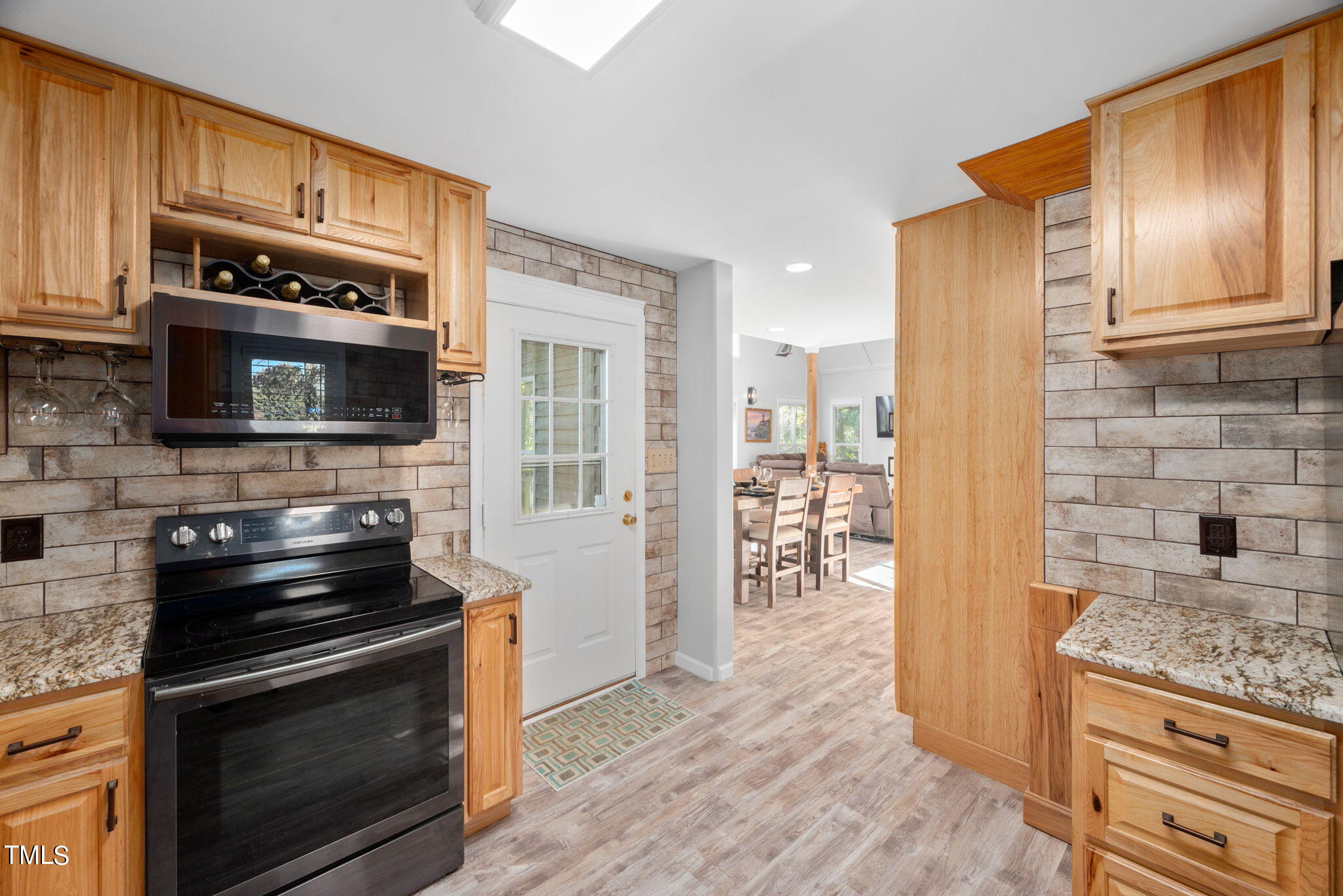427 Mason Road Durham, NC 27712 - Photo 5 of 29 a kitchen with granite countertop wooden cabinets and stainless steel appliances
