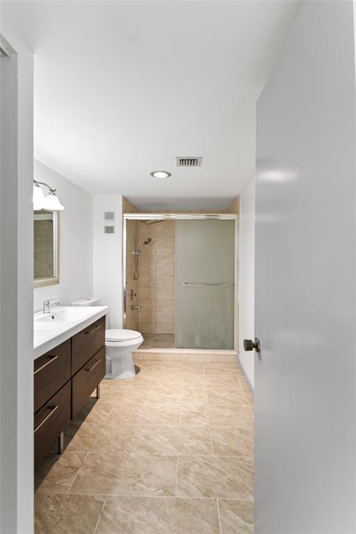 6300 Northwest 2nd Avenue, Unit 405 Boca Raton, FL 33487 - Photo 16 of 37 a bathroom with a double vanity sink toilet mirror and bathtub