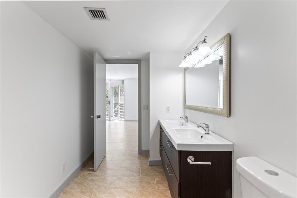 6300 Northwest 2nd Avenue, Unit 405 Boca Raton, FL 33487 - Photo 17 of 37 a bathroom with a sink and a mirror