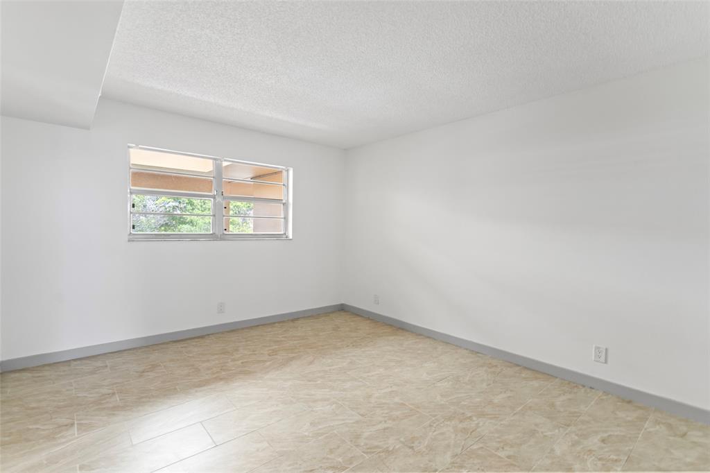 6300 Northwest 2nd Avenue, Unit 405 Boca Raton, FL 33487 - Photo 20 of 37 an empty room with a window