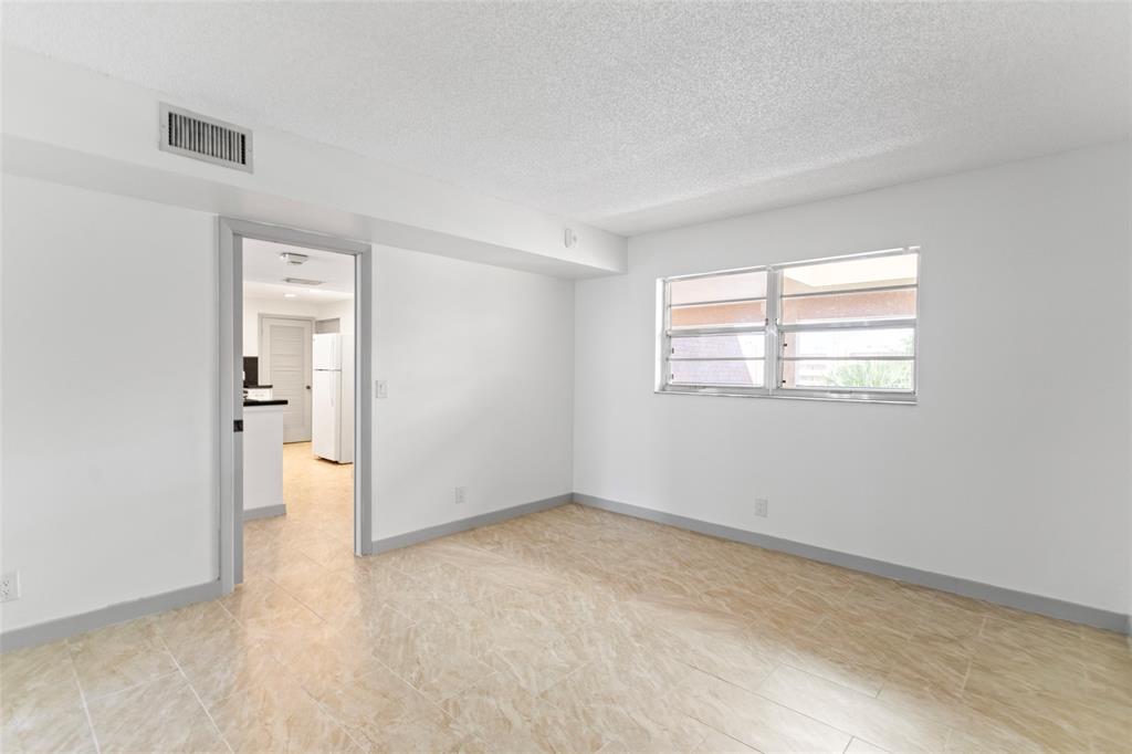 6300 Northwest 2nd Avenue, Unit 405 Boca Raton, FL 33487 - Photo 23 of 37 an empty room with windows and closet