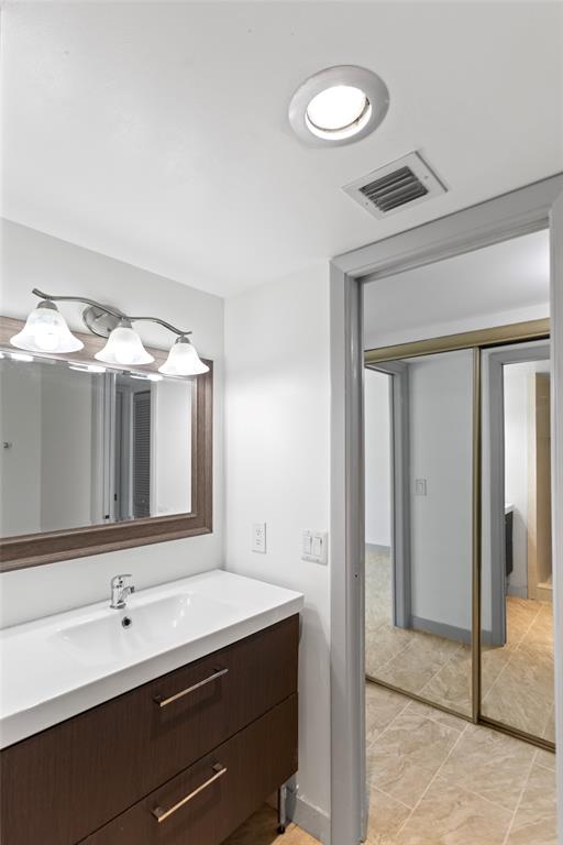6300 Northwest 2nd Avenue, Unit 405 Boca Raton, FL 33487 - Photo 26 of 37 a bathroom with a double vanity sink and a mirror