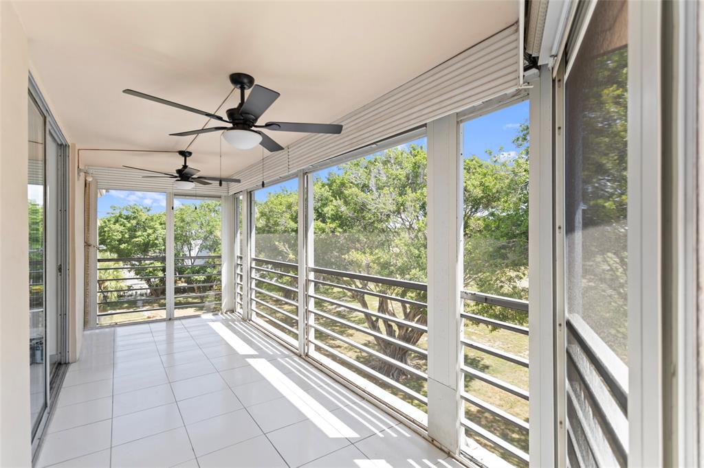6300 Northwest 2nd Avenue, Unit 405 Boca Raton, FL 33487 - Photo 33 of 37 a view of a room with a ceiling fan and a porch
