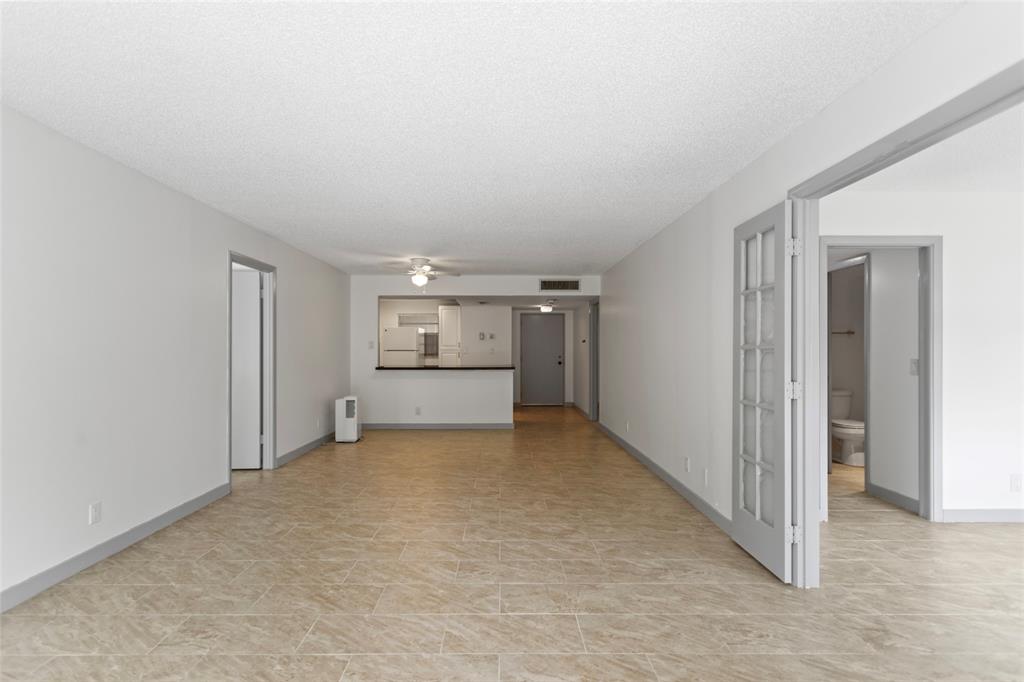 6300 Northwest 2nd Avenue, Unit 405 Boca Raton, FL 33487 - Photo 6 of 37 a view of an empty room and kitchen