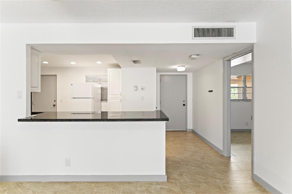 6300 Northwest 2nd Avenue, Unit 405 Boca Raton, FL 33487 - Photo 9 of 37 a view of a kitchen with stainless steel appliances granite countertop cabinets and a granite counter tops