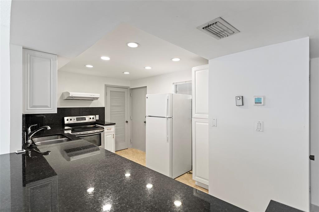 6300 Northwest 2nd Avenue, Unit 405 Boca Raton, FL 33487 - Photo 10 of 37 a view of a kitchen with a refrigerator and a stove top oven