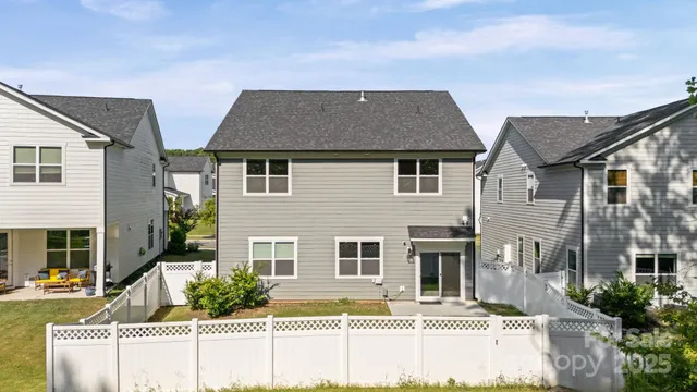 a view of house with backyard
