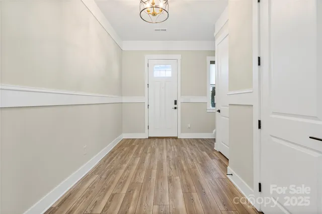 a view of a room with wooden floor and white walls