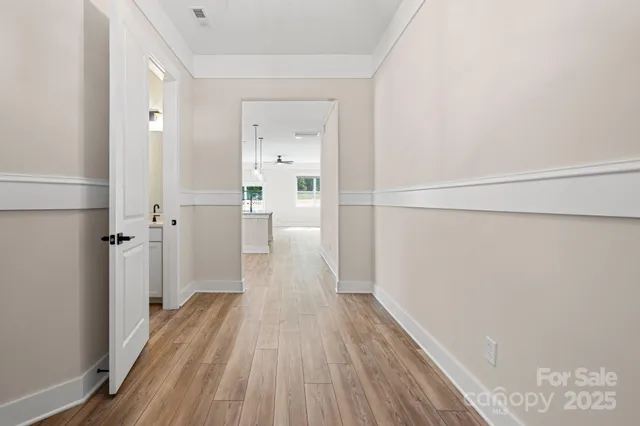 a view of a room with wooden floor