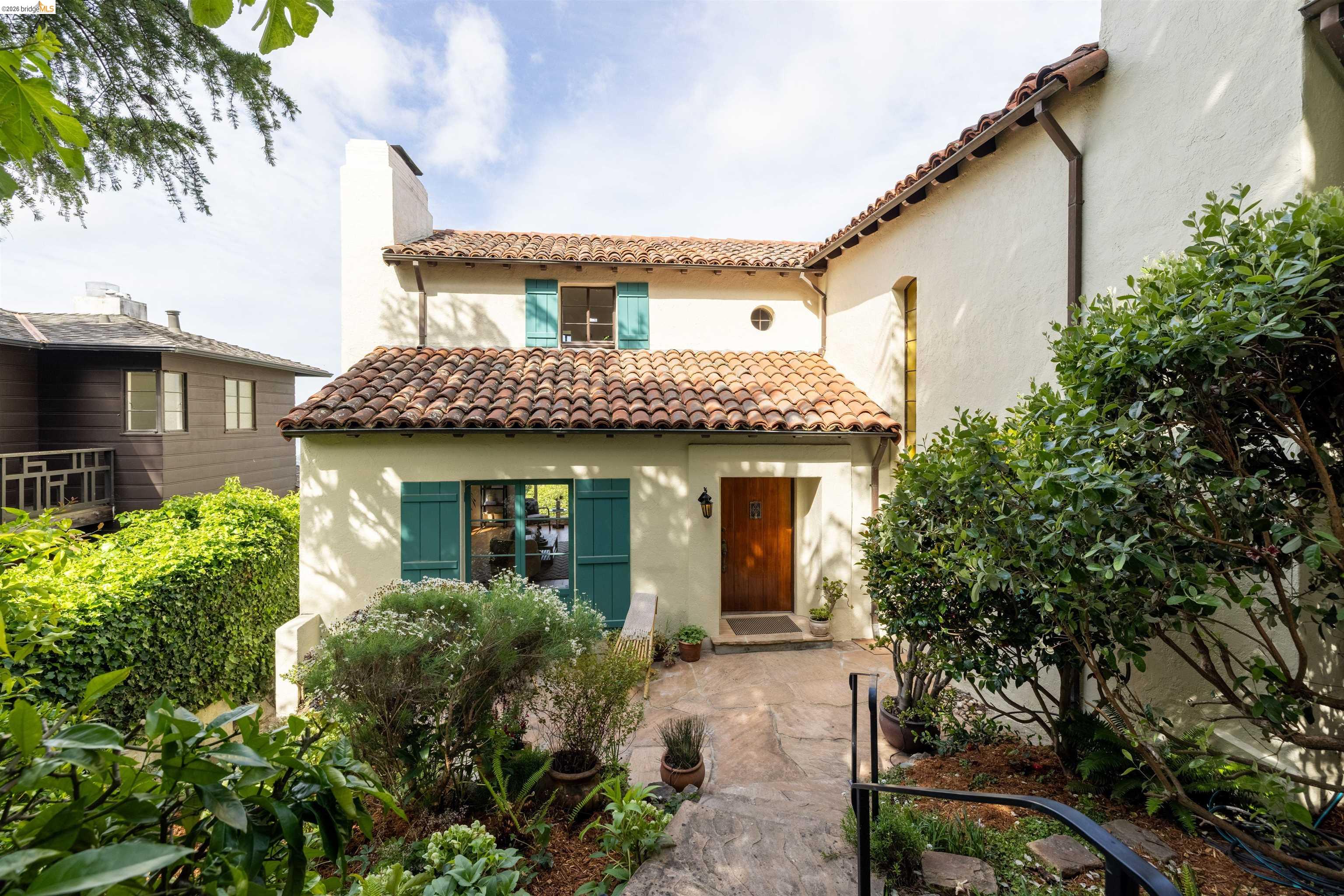 a front view of a house with garden