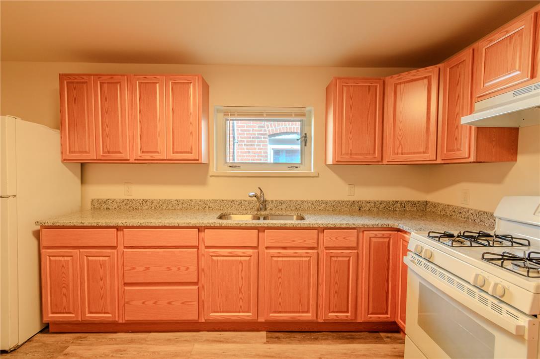 820 North 5th Street Allentown, PA 18102 - Photo 18 of 39 Functional kitchen with ample cabinet space, offering granite counters and a practical layout.