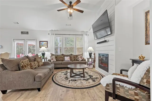 a living room with furniture a fireplace and a flat screen tv