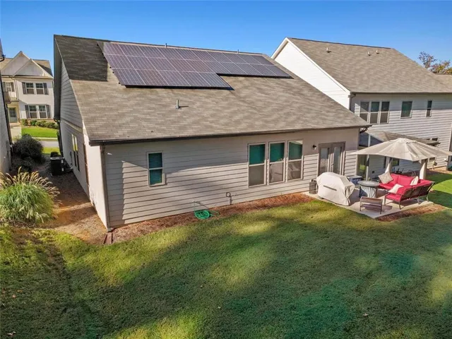 an aerial view of a house with a yard