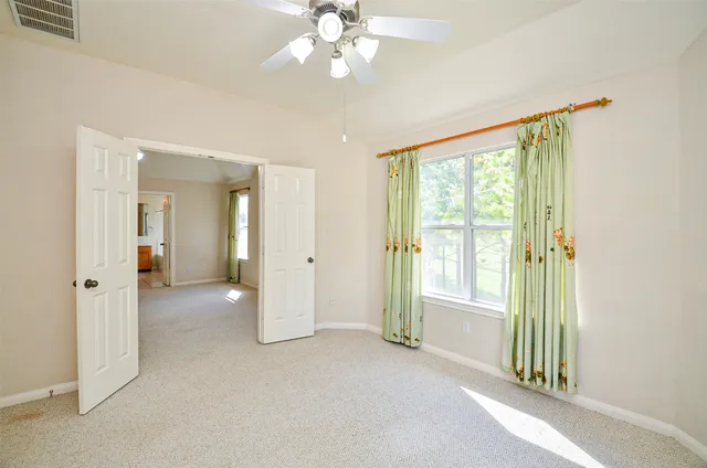 an empty room with windows and outdoor view