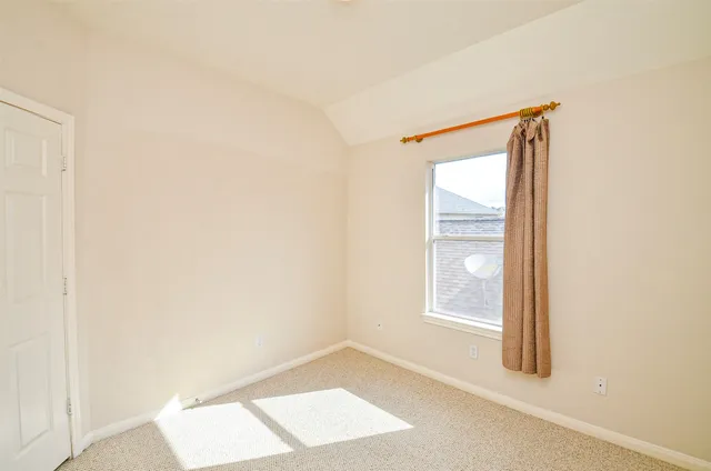 an empty room with windows and closet