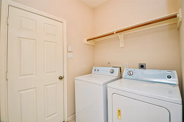 a view of storage and utility room with washer and dryer