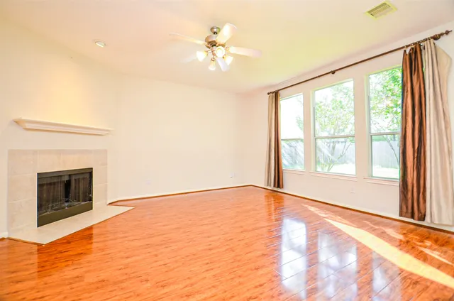 a view of an empty room with glass door and a window