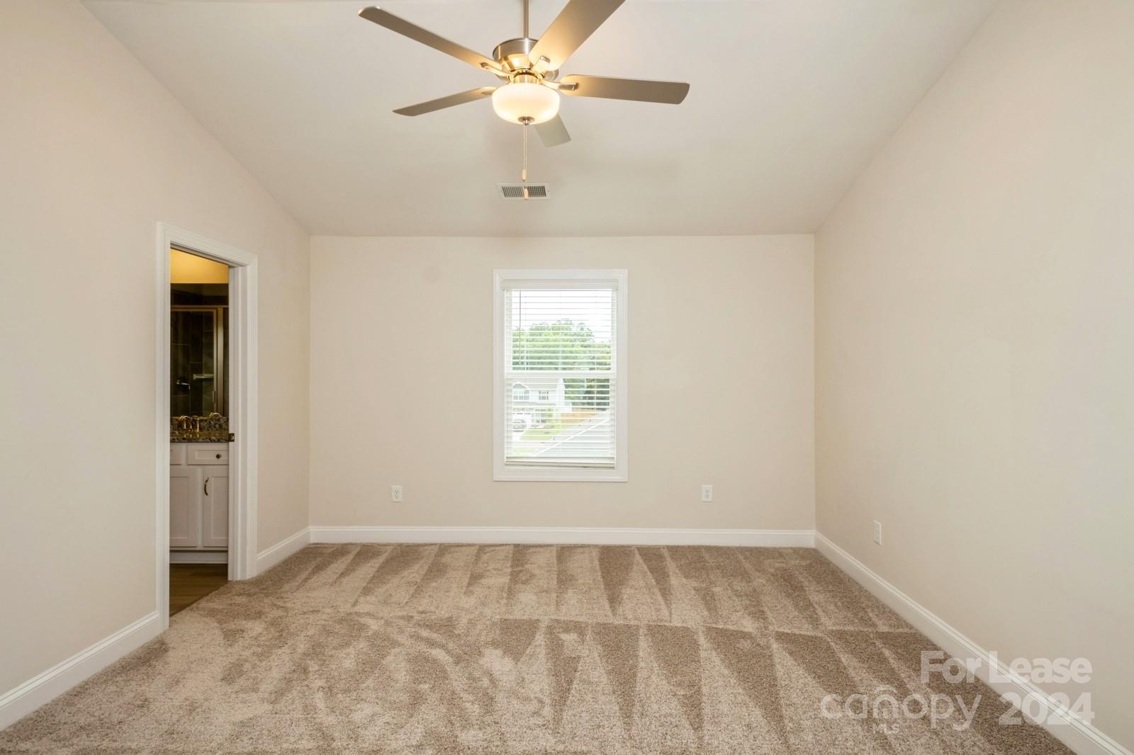 131 Brixham Loop Troutman, NC 28166 - Photo 11 of 26 an empty room with a window and a fan