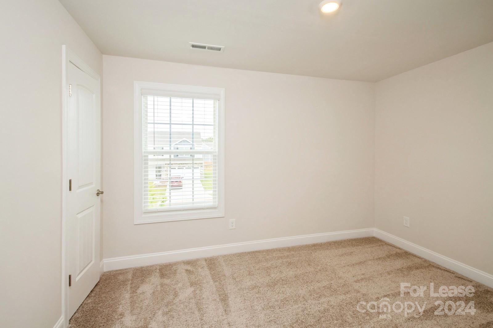 131 Brixham Loop Troutman, NC 28166 - Photo 16 of 26 an empty room with a window