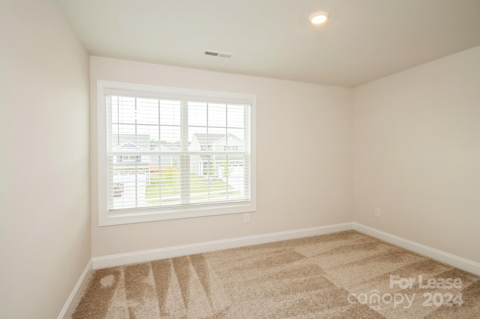 131 Brixham Loop Troutman, NC 28166 - Photo 18 of 26 an empty room with a window