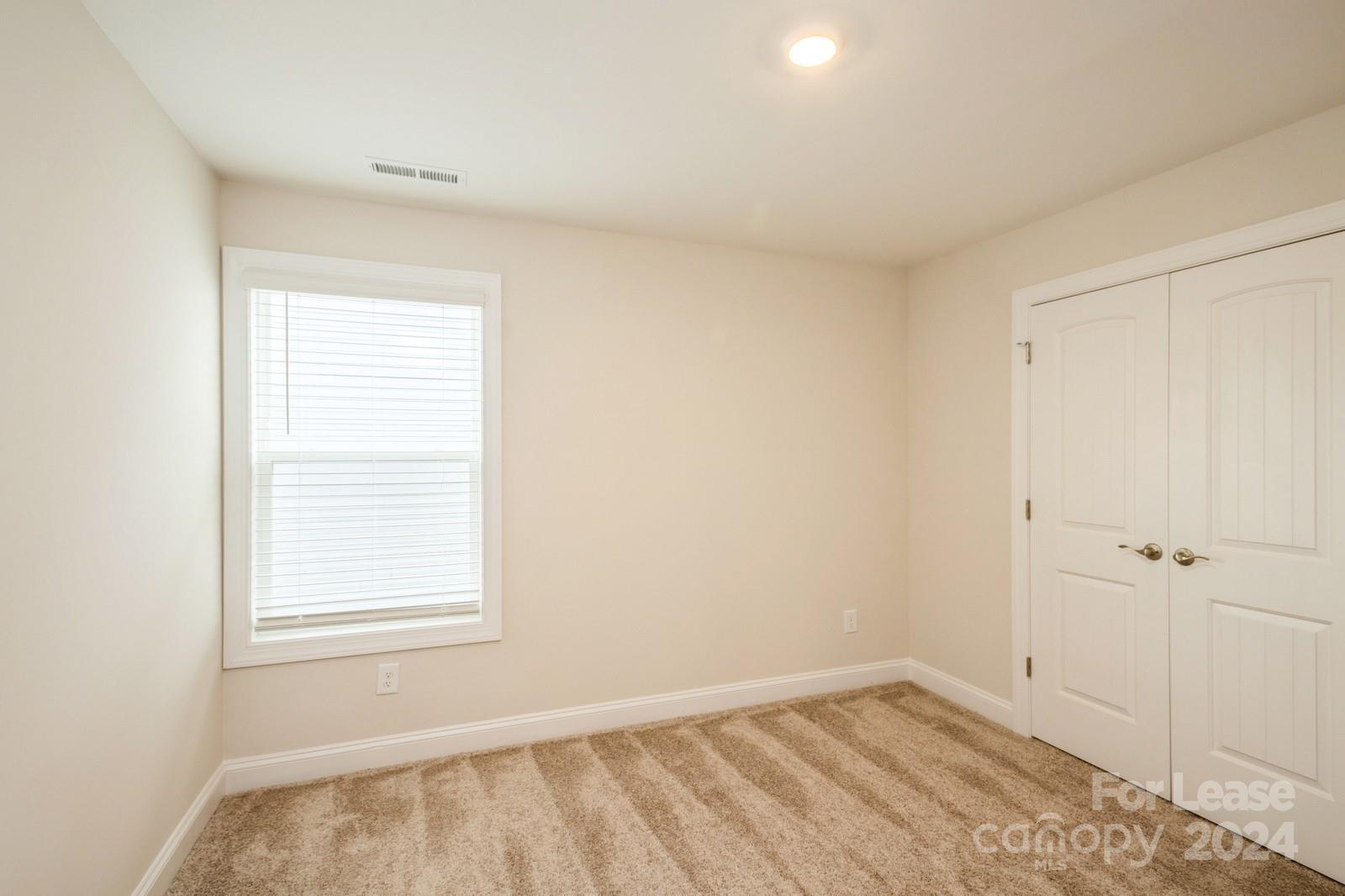 131 Brixham Loop Troutman, NC 28166 - Photo 20 of 26 an empty room with a window